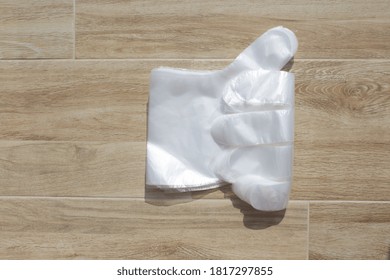 White Polyethylene Gloves Pandemic 2020 Part Of The Left Glove On A Light Background Top View Like Sign