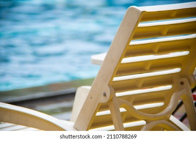 White Pool Chair In The Edge Of The Swimming Pool