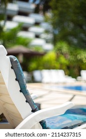 White Pool Chair In The Edge Of The Swimming Pool