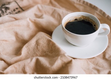 White Porcelain Cup With Black Coffee, Espresso On A Beige Background, Tea Towel