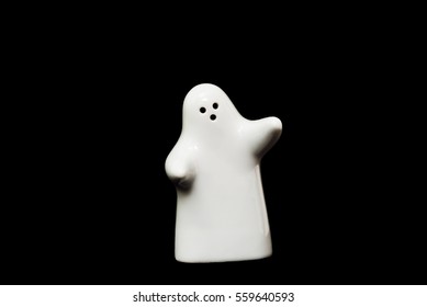 White Porcelain Figurine On Black Background