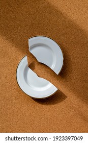 white porcelain plate broken into two parts, one half in the shade, the other in the light, creative design, divorce or quarrel concept - Shutterstock ID 1923397049