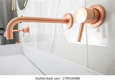 White Porcelain Sink With Copper Faucet, Knob, And Soap Dispenser.