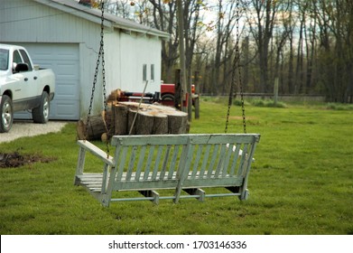 White Porch Swing Hanging From Tree