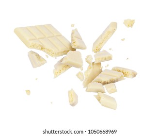 White porous chocolate broken into pieces in the air, isolated on a white background