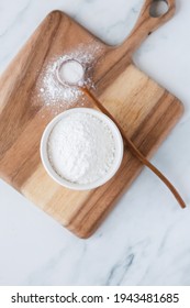 White Powder In Bowl With Wooden Spoon