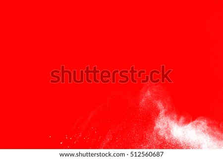 white powder explosion isolated on red background