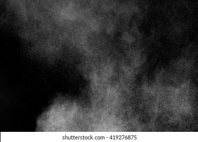 White Powder Explosion On Black Background. Abstract White Dust Texture.