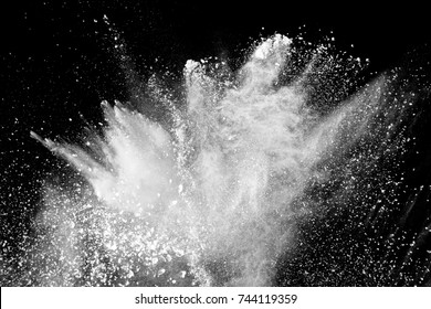 White Powder Explosion On Black Background.