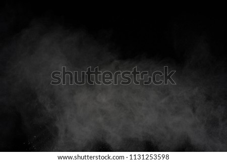 White powder explosion on black background. Freeze motion of colored powder explosion isolated.