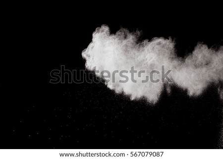 White powder explosion on black background. Mauve color cloud. White  dust explode. Freeze motion paint Holi.