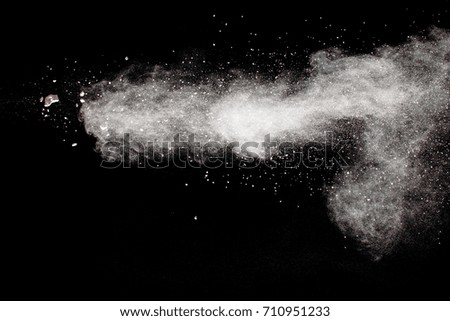 White powder explosion on black background.Stopping the movement of white powder on dark background.