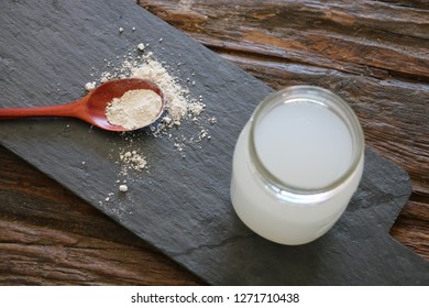 White Powder Silica On Black Board With Glass Of Silica Drink Next To It In Glass Jar