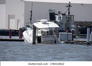 White Power Boat Sinking In Marina Slip