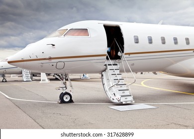 White Private Business Jet And Open Ladder At The Airport