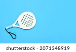 White professional paddle tennis racket on blue background. Horizontal sport theme poster, greeting cards, headers, website and app
