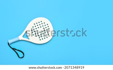 White professional paddle tennis racket on blue background. Horizontal sport theme poster, greeting cards, headers, website and app