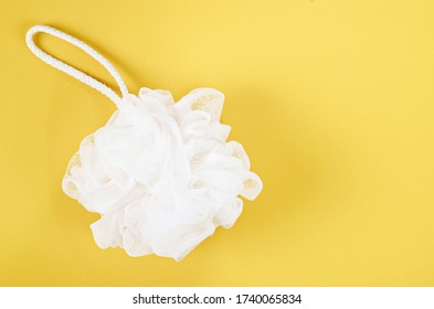 White puff Shower sponge mesh, bath body scrubber on yellow background. - Powered by Shutterstock