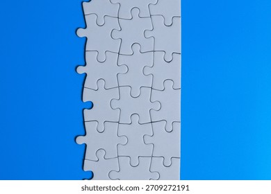 White puzzle frame in the center with missing pieces, surrounded by blue background on both left and right sides, representing problem solving, clarity, strategy, and finding solutions. - Powered by Shutterstock - Get 15% off with code: PIKWIZARD15