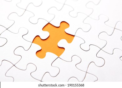 White Puzzle Piece Missing On Orange Background 