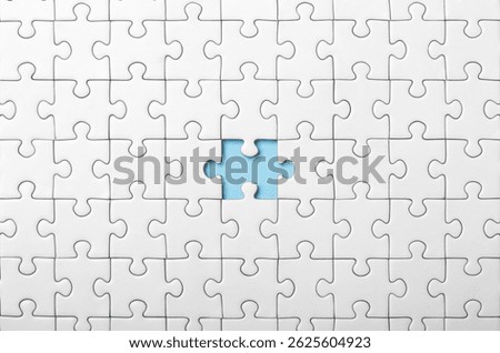 White Puzzle with Single Missing Piece Revealing blue Background