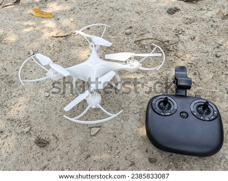 white quadcopter drone and remote