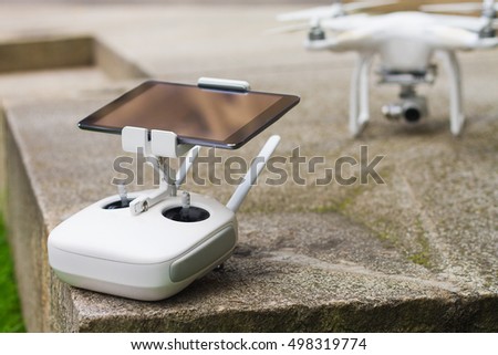 White quadrocopter with remote control, close-up. New unmanned aerial copter. Electronics innovation.Aeromodelling. Modern Technologies. 