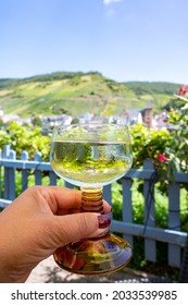 White Quality Riesling Wine Served In Yellow Swirl Wine Glass On Outdoor Terrace In Mosel River Wine Region, Germany