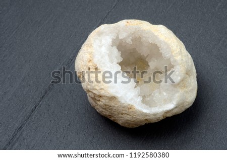 white quartz geode, mineral close up, on slate board