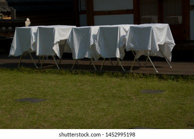 A White Quilt Hanging In The Yard