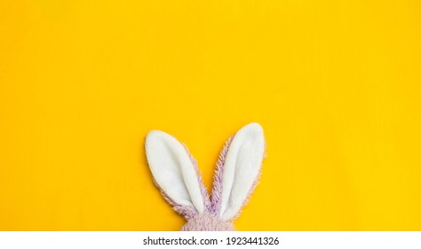 White Rabbit Ears On Yellow Fabric Background, Easter Concept Background