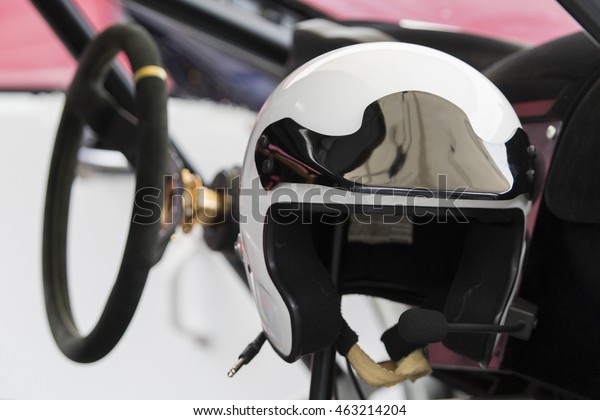 white racing helmet in a\
sports car