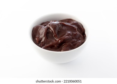 White Ramekin Filled With Creamy Chocolate Sauce, Against White Background