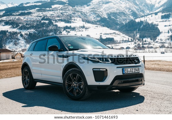 White Range Rover Evoque. Austria, Alps - March 25,\
2018: Latest brand new white 2018 Range Rover Evoque. Beautiful car\
SUV in the nature deep in Alps. Range Rover bestselling model in\
the wild.