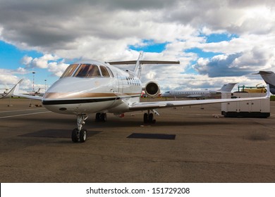 White Reactive Private Jet, The Front Landing Gear On Blue Sky And Clouds