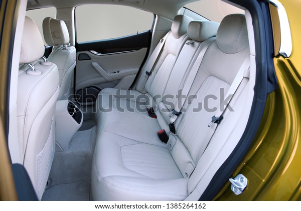 white rear seat of a\
luxury passenger car