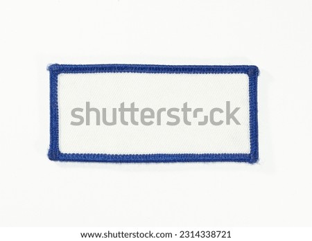 White rectangular patch with blue trim.