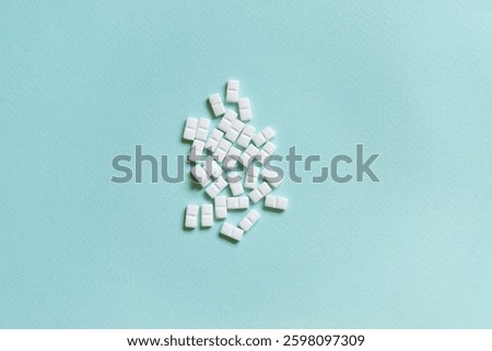 white rectangular pills on blue background, medical treatment	