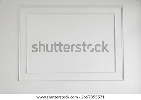 White rectangular trim molding on clean wall. Classic interior design element for home decor background. Simple blank space.