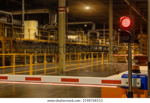 White and red Barrier Gate or Barrier fences and\
symbol lights used to control the passage of cars in the factory\
for safety\
