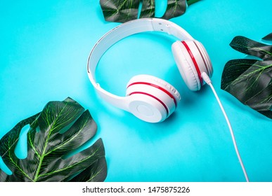 White Red Music Headphones On Technology Background Notbook Computer On A Blue Background. Happy Holidays.