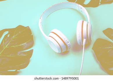 White Red Music Headphones On Technology Background Notbook Computer On A Blue Background. Happy Holidays.