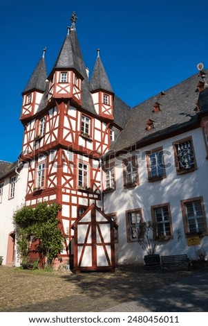 A white and red skyscraper with trees in foreground, Siegfrieds Mechanical Music Cabinet, Rudesheim, Germany