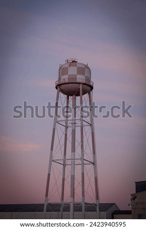 A white and red water tower at sunset at Hendy Avenue,  Sunnyvale landmark