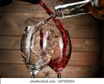 White And Red Wine Pouring On Wood Background