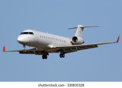 White Regional Jet Airplane Approaching Runway