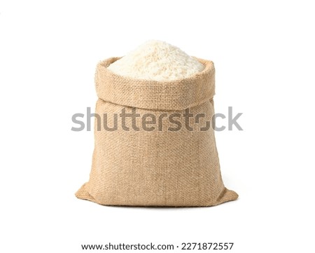 White rice in burlap sack bag isolated on white background.