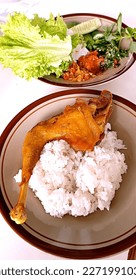 White rice featuring friedchicken and vegetables