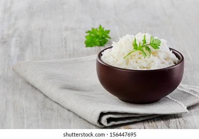 White rice on a wooden table. Selective focus