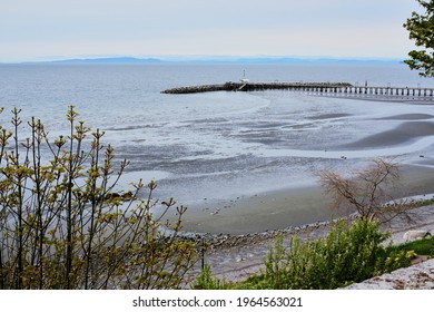 White Rock beach and pier at low tide.  On the horizon, sit BC's Gulf Islands.  Spring 2021
